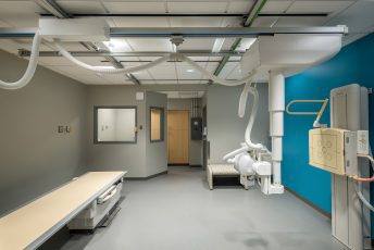 Modern hospital X-ray room with equipment.