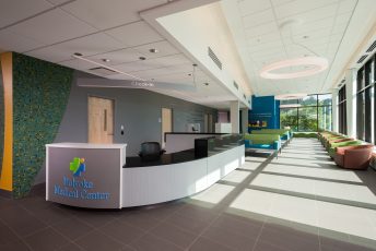 Modern medical center reception area with seating.