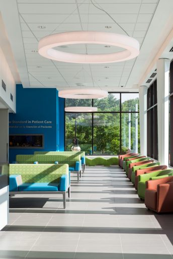 Modern hospital waiting area with colorful seating.