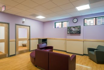 Modern waiting room with purple walls.