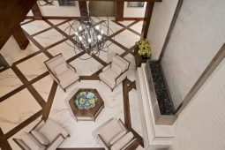 Modern lobby with chairs and geometric flooring.