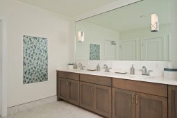 Modern bathroom with double sinks and mirror.
