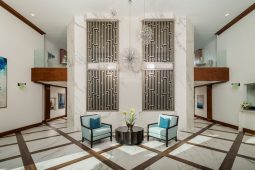 Modern lobby with chairs and geometric decor.